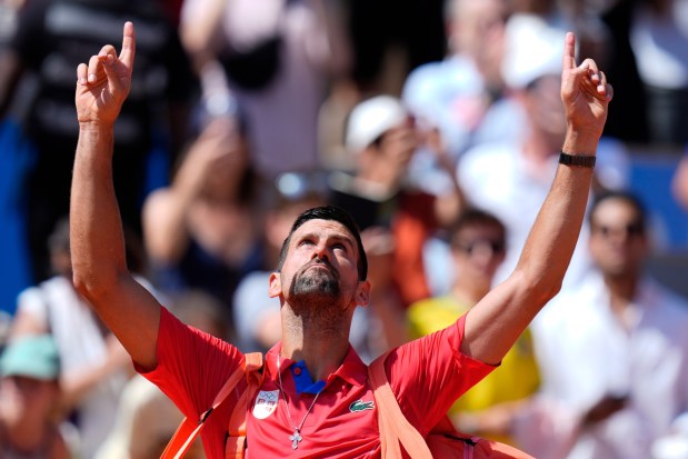 Serbia's Novak Djokovic gestures as he leaves the court after defeating Spain's Rafael Nadal in their men's singles second round match at the Roland Garros stadium at the 2024 Summer Olympics, Monday, July 29, 2024, in Paris, France. Novak Djokovic dominated rival Rafael Nadal to win 6-1, 6-4 at the Paris Olympics in the second round. (AP Photo/Andy Wong)