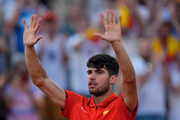 Carlos Alcaraz of Spain celebrates after defeating Tallon Griekspoor of the Netherlands in their men's singles second round match, at the 2024 Summer Olympics, Monday, July 29, 2024, at the Roland Garros stadium in Paris, France. (AP Photo/Andy Wong)