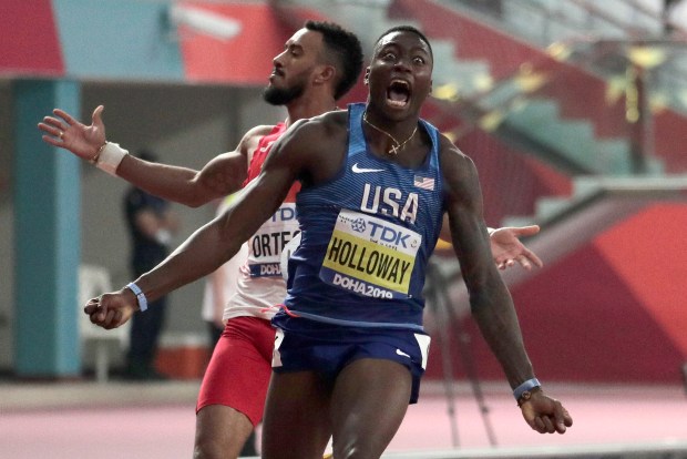 Grant Holloway, who grew up in Chesapeake, celebrates winning the gold medal in the men's 110 meter hurdles final at the World Athletics Championships in Doha, Qatar, on Oct. 2, 2019.