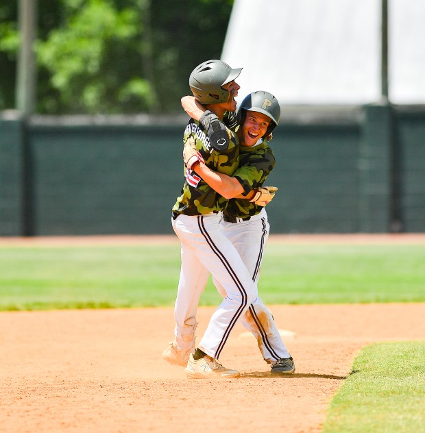 Poquoson's Eli Tyndall hugs TJ Check after the Islanders won the state title on Saturday, June 8, 2024.