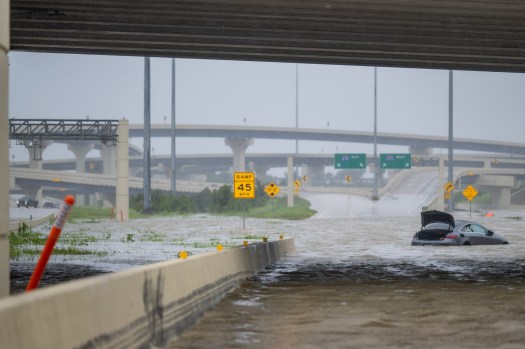 A vehicle is left abandoned in floodwater on a highway after Hurricane Beryl swept through the area on July 08, 2024 in Houston, Texas. There’s no place on Earth that’s entirely safe from climate change. (Photo by Brandon Bell/Getty Images)
