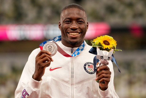 Silver medalist Grant Holloway, of the United States, poses during the medal ceremony for the men's 110-meter hurdles at the 2020 Summer Olympics, Thursday, Aug. 5, 2021, in Tokyo.