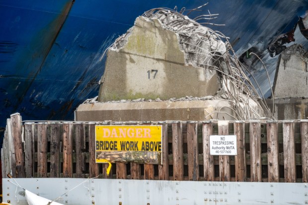 April 2, 2024: The remains of a structural support pier of the Francis Scott Key Bridge is seen next to the container ship Dali. A week ago the ship lost power and hit the structural pier causing a catastrophic bridge collapse. (Jerry Jackson/Staff)