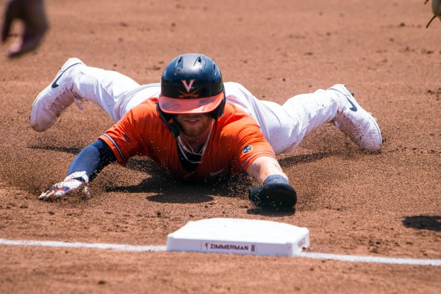 Virginia's Ethan Anderson, a Cox High graduate, slides into third base against Duke during a 2023 NCAA Super Regional in Charlottesville. JOHN C. CLARK/AP