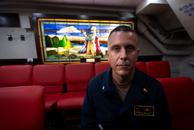 Chaplain Marlin Williams sits for a portrait in the faith center aboard the USS George Washington (CVN-73) off the coast of Florida on September 15, 2023. "It ripples into the leadership, the whole command , and the whole fleet when people hear of the death," Williams said of the suicides onboard. (Billy Schuerman / The Virginian-Pilot)