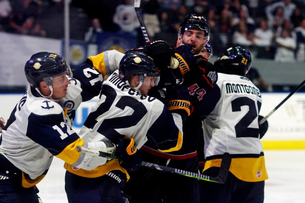 Stepan Timofeyev #22 of the Norfolk Admirals and Darian Skeoch #44 of the Adirondack Thunder start to fight during overtime of game 3 of the North Division Finals in the Kelly Cup Playoffs at the Scope in Norfolk, Va., May 8, 2024. The Norfolk Admirals lost 2-1 in overtime. (Peter Casey / For The Virginian-Pilot)