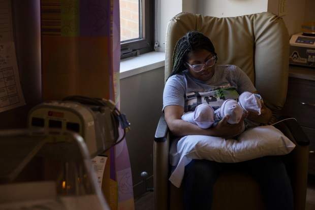 Tayshana Jones takes a moment while holding her triplets in the neonatal intensive care unit at Sentara Norfolk General Hospital on Monday, June 17, 2024. (Kendall Warner / The Virginian-Pilot)