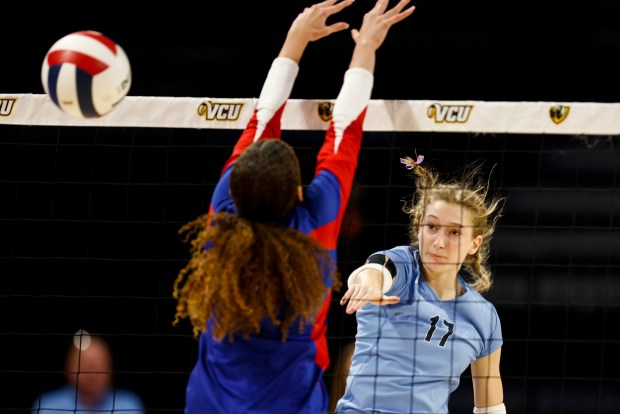 First Colonial's Gabby Taylor (17) spikes the ball around a Riverside defender during the Class 5 state championship. (Billy Schuerman / The Virginian-Pilot)