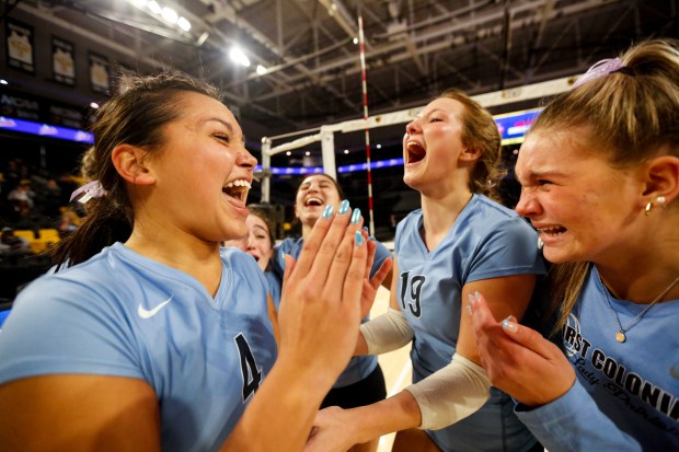 First Colonial's Kaiyah Hiles (4) celebrates with teammates after the Patriots won the Class 5 state championship. (Billy Schuerman / The Virginian-Pilot)