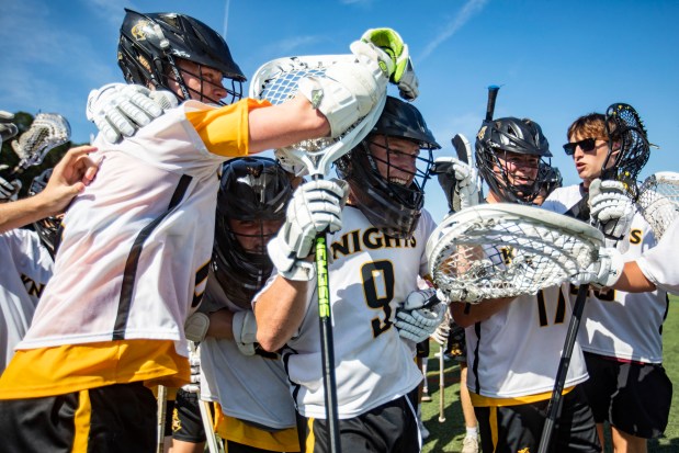 Kellam teammates rally around goalie Gavin Sinram (9) after defeating Patrick Henry of Roanoke 9-4 during a Class 5 state semifinal game at Floyd E. Kellam High School in Virginia Beach on Tuesday, June 4, 2024. (Kendall Warner / The Virginian-Pilot)