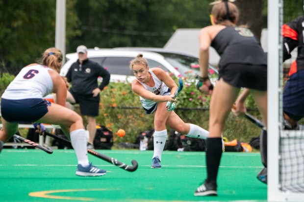 Norfolk Academy forward Gretchen Scott, center, takes a shot on goal during a game against Cox at on Sept. 27. (Mike Caudill / For The Virginian-Pilot)