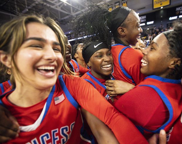 Princess Anne players rush the court after Princess Anne defeated James River 80-70 in the VHSL Class 5 State Championship at the Siegel Center in Richmond, Virginia, on March 9, 2024. (Billy Schuerman / The Virginian-Pilot)