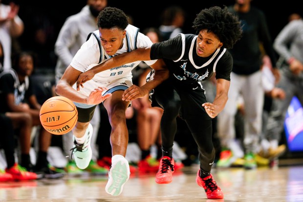 Woodside's Travis Hamilton (1) chases down the ball with L.C. Bird's John Uzochukwu (11). Woodside defeated L.C. Bird 53-33 in the VHSL Class 5 State Championship at the Siegel Center in Richmond, Virginia, on March 9, 2024. (Billy Schuerman / The Virginian-Pilot)