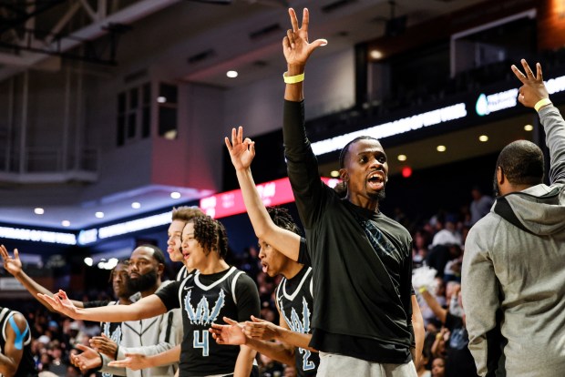 Woodside head coach Stefan Welsh holds up three fingers to celebrate a late three-point shot from Jakobe Reed. Woodside defeated L.C. Bird 53-33 in the VHSL Class 5 State Championship at the Siegel Center in Richmond, Virginia, on March 9, 2024. (Billy Schuerman / The Virginian-Pilot)