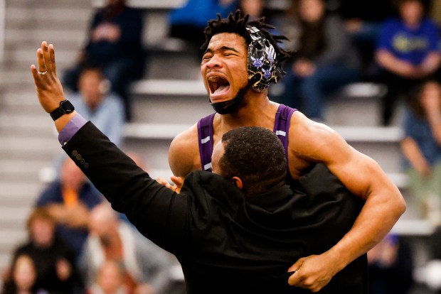 Deep Creek Samuel Diggs is hoisted by Deep Creek head coach Travis Ferguson after diggs pinned his opponent in the final seconds for a come-from-behind victory in the class 6 weight class 175 state championship. Athletes competed in the VHSL Wrestling State Championships for classes 4, 5, and 6, at the Virginia Beach Sports Center in Virginia Beach, Virginia, on Feb 17, 2024. (Billy Schuerman / The Virginian-Pilot)