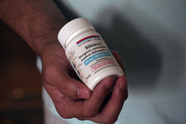 Fernando Hermida holds a bottle of Biktarvy, his HIV medication, in Charlotte, North Carolina, on May 27, 2024. Hermida received a $1,275 bill earlier this year for the medication, one of the reasons he decided to move to find more affordable treatment. (Laura Bargfeld/AP/KFF Health News/TNS)