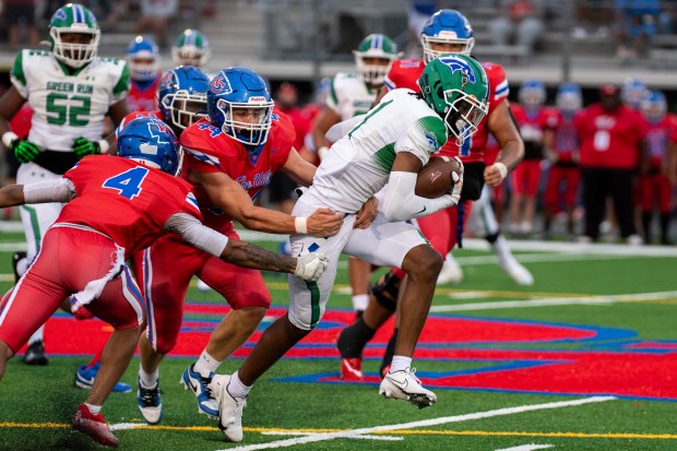 Green Run wide receiver Keylen Adams, right, fights for extra yards against Kempsville during an Aug. 24 game. Adams has the VHSL career records for touchdowns and receiving yards. (Mike Caudill/Freelance)